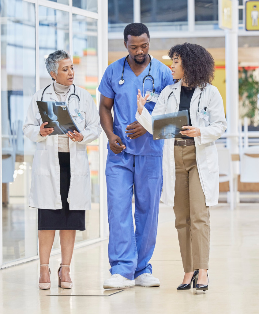 Three doctors are discussing X-rays.